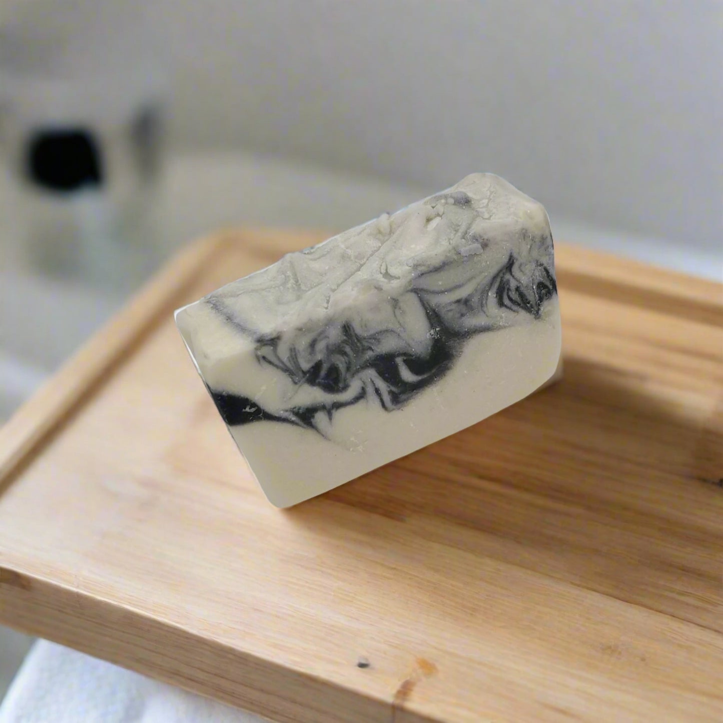 An intriguing white and black soap, featuring activated charcoal, cocoa butter and shea butter.